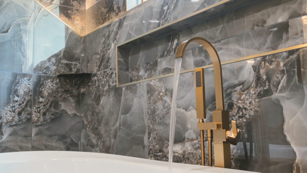 Alpenglow Builders LLC - Alpenglow Builders LLC luxury bathroom with marble walls and modern gold fixtures in Palmer, Alaska.
