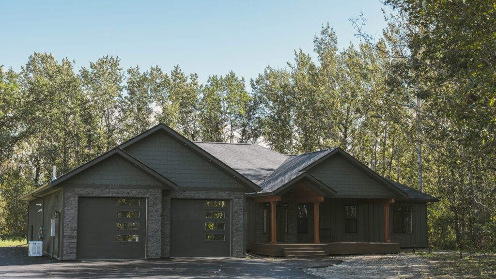 Alpenglow Builders LLC - Alpenglow Builders LLC: Custom luxury home in Palmer, Alaska, featuring modern design, stone accents, and a spacious garage a.
