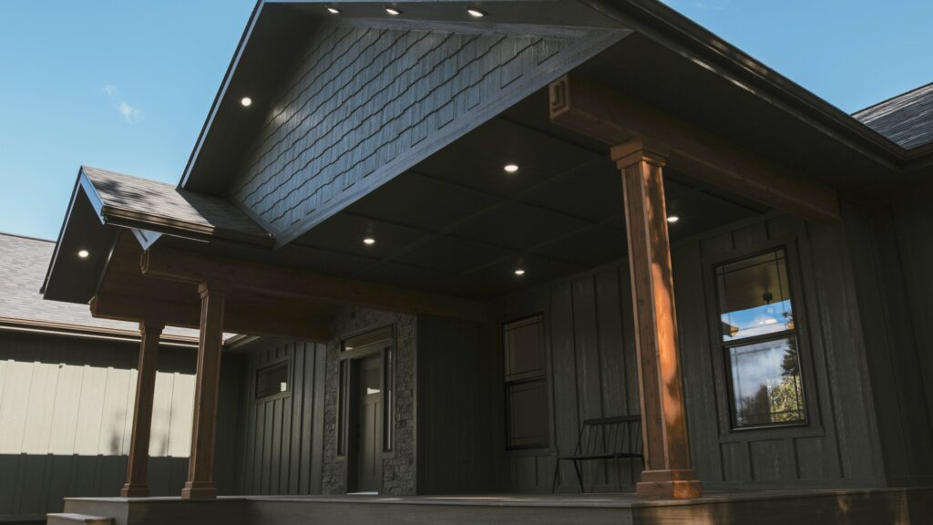 Alpenglow Builders LLC - A high-end custom luxury home in Palmer, Alaska, showcasing modern architectural design with dark exterior siding and wooden.
